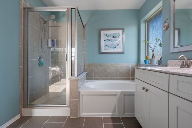 Bathroom with a shower stall, a bath, and vanity | Image 11
