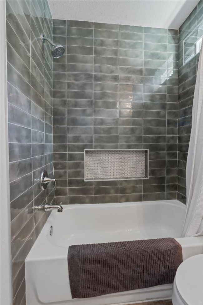 Full bathroom featuring shower / tub combo and toilet | Image 25