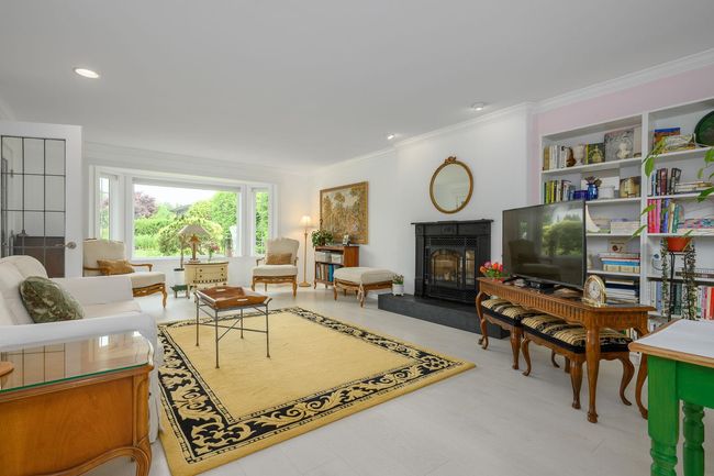 Living room featuring ornamental molding, a glass covered fireplace, and recessed lighting | Image 5