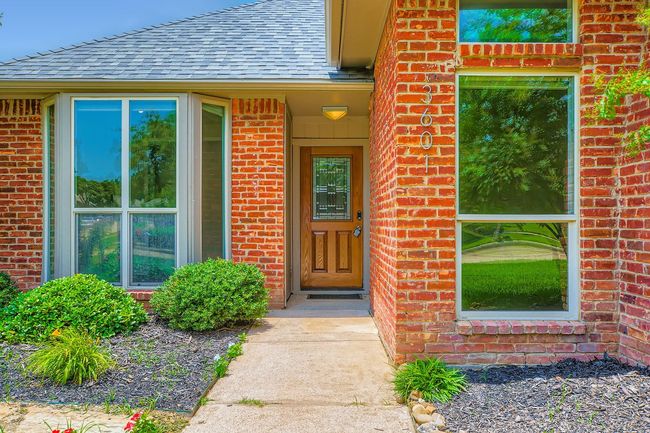 Property entrance featuring brick siding and a shingled roof | Image 26