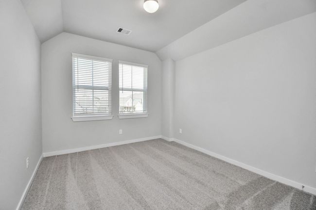 Generously sized secondary bedrooms featuring spacious closets, soft and inviting carpeting underfoot, large windows allowing plenty of natural light, and the added touch of privacy blinds for your personal retreat. | Image 30