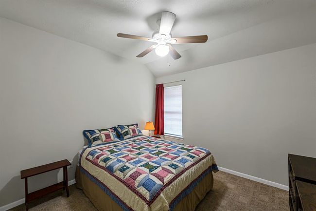Secondary bedroom #2 with low-pile carpet and high ceiling. | Image 16