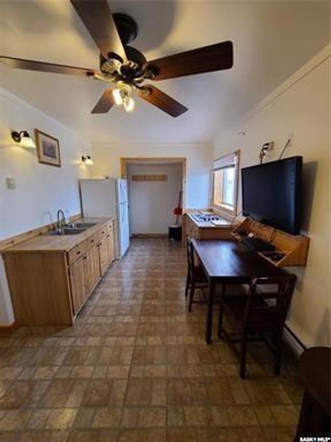 Kitchen with ceiling fan, sink, and white refrigerator | Image 23