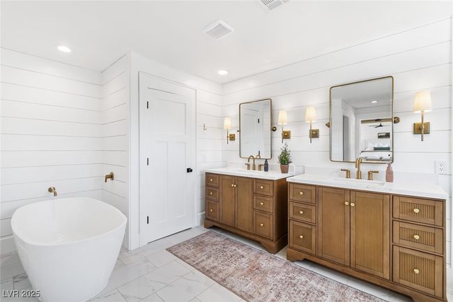 Full bathroom with two vanities, a soaking tub, marble finish floor, and a sink | Image 27