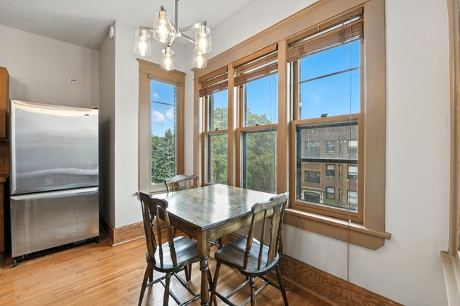 Cozy dining space next to the kitchen with abundant natural light and easy access to food prep. | Image 17