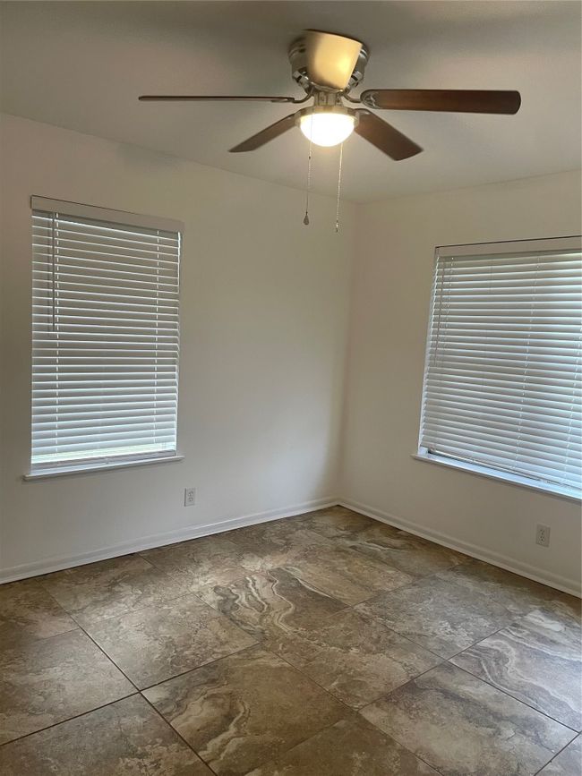 Spare room with stone finish flooring and ceiling fan | Image 13