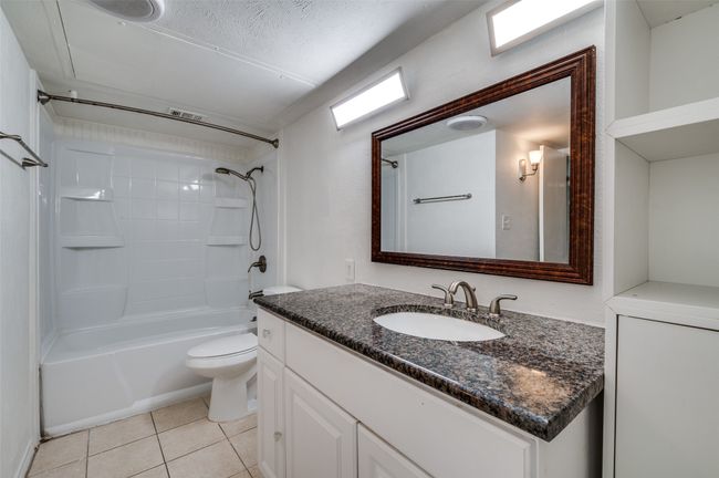 Bathroom featuring vanity, bathing tub / shower combination, and tile patterned flooring | Image 13