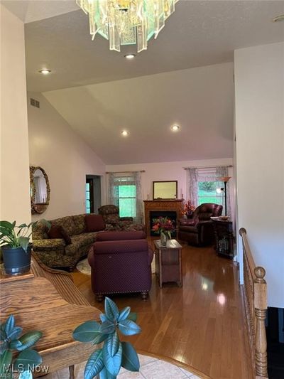 Living room featuring lofted ceiling and hardwood / wood-style floors | Image 2