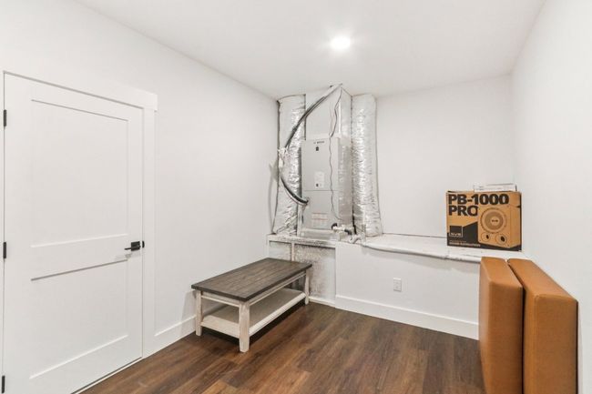 Mudroom with dark wood-style floors and heating unit | Image 31