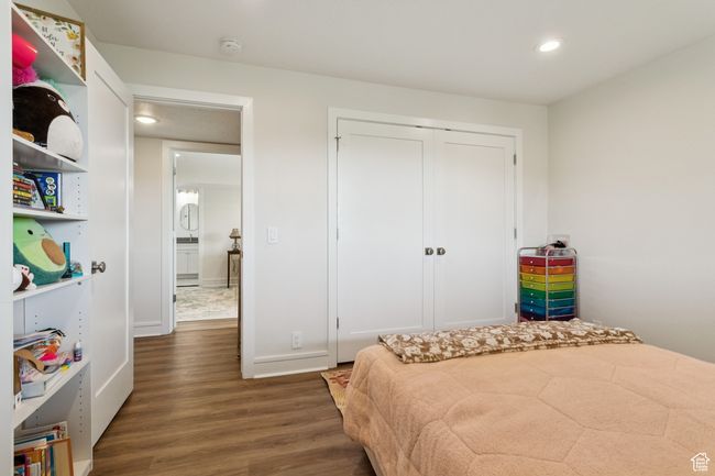 Bedroom featuring wood finished floors, recessed lighting, and a closet | Image 29