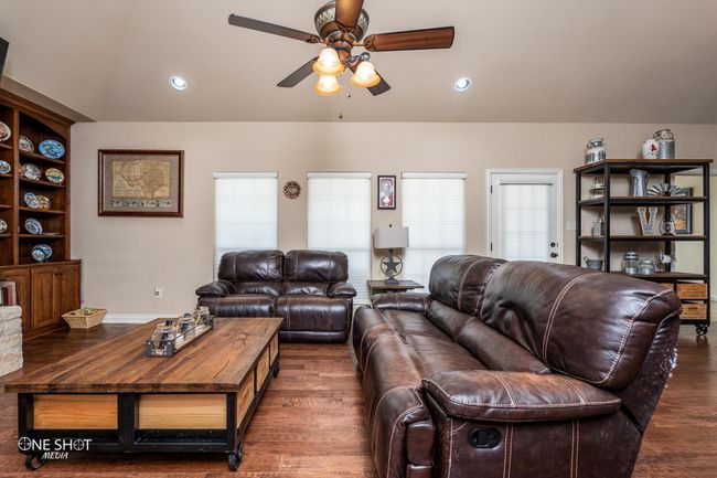 Living room featuring ceiling fan, wood finished floors, and recessed lighting | Image 8
