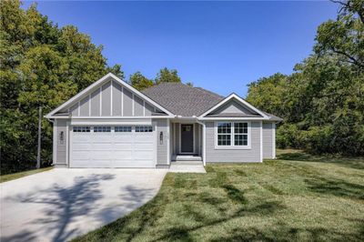 View of front of home featuring a front yard and a garage | Image 1