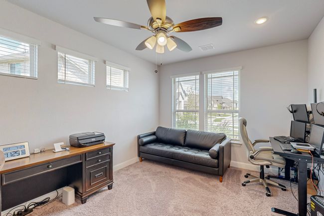 Office area with light carpet, visible vents, plenty of natural light, and a ceiling fan | Image 28