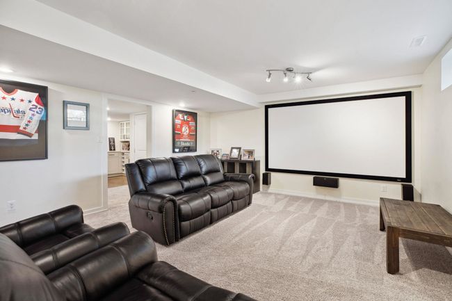 Carpeted home theater room featuring baseboards | Image 30