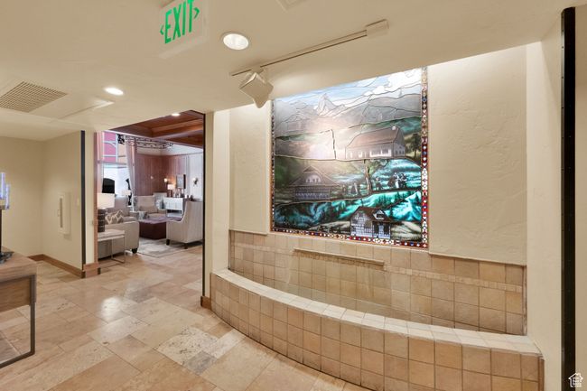 Interior space with baseboards, visible vents, and stone tile flooring | Image 8