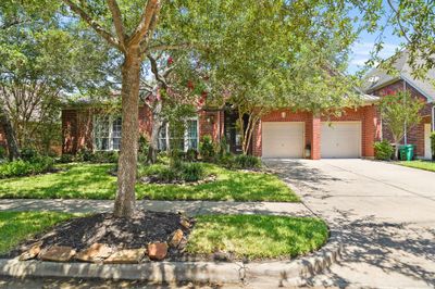 Plenty of parking! Pull into your gracious two-car garage or find plenty of extra space in your double wide driveway. | Image 3