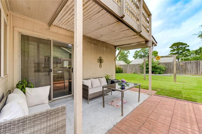 Enjoy the perfect blend of comfort and charm with a fully covered porch—ideal for relaxing mornings or cozy evenings. The cute, private backyard offers just the right amount of space for gardening, pets, or entertaining | Image 8
