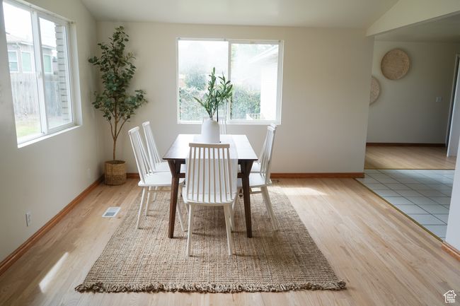 Dining space featuring wood finished floors and lofted ceiling | Image 11