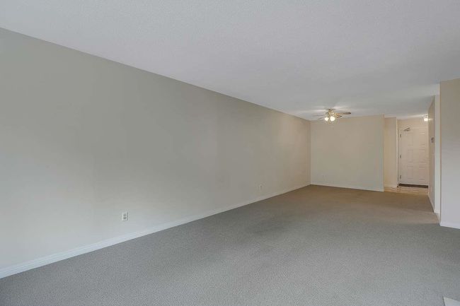 Empty room featuring ceiling fan and carpet floors | Image 7
