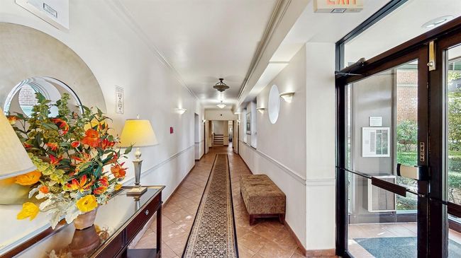 Hall featuring inlaid floor details, ornamental molding, and tile patterned floors | Image 20