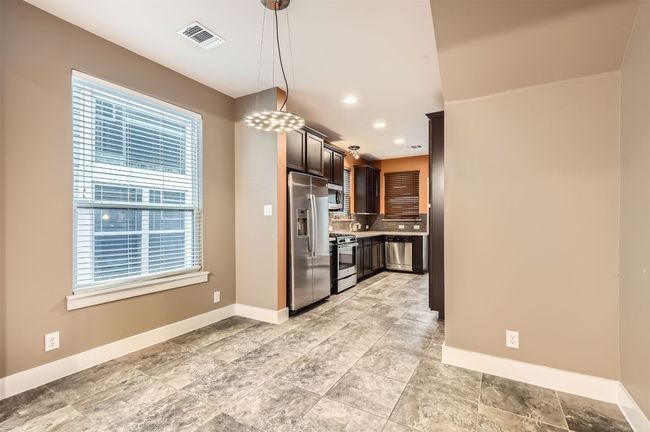 Kitchen with stainless steel appliances, backsplash, light countertops, pendant lighting, and recessed lighting | Image 9