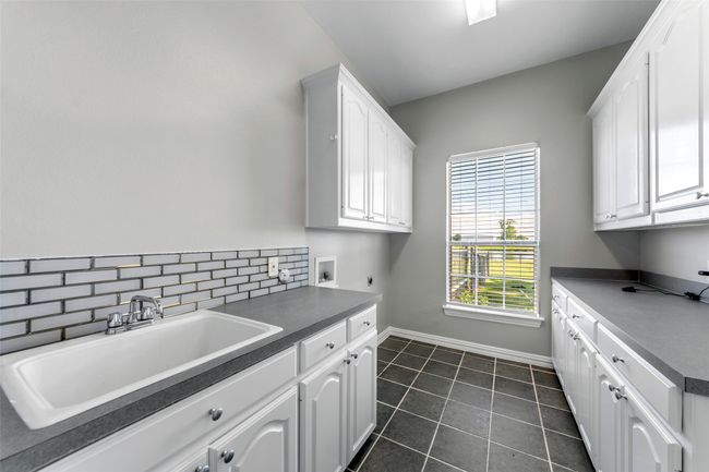 UTILITY ROOM...Tile Floor, Sink, Built-Ins | Image 30