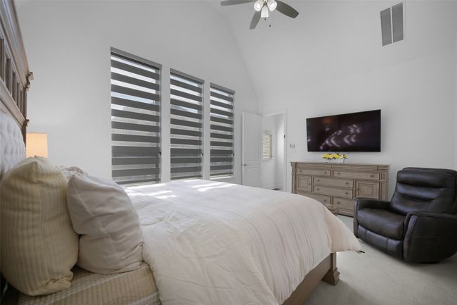 Primary Bedroom featuring high vaulted ceiling. | Image 17