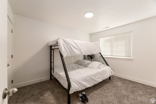 Carpeted bedroom featuring visible vents and baseboards | Image 17