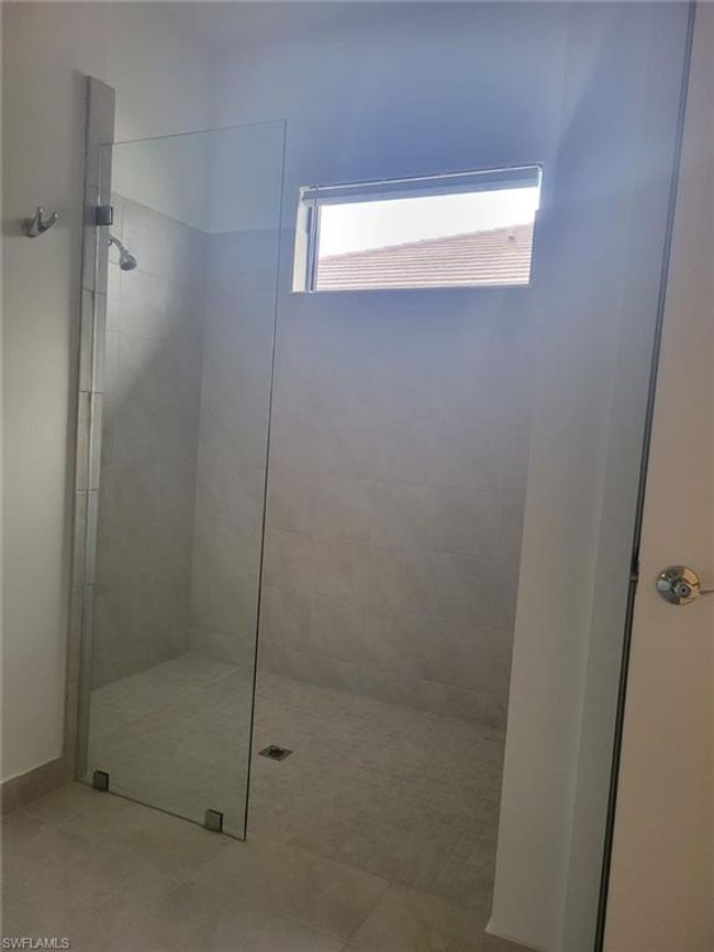 Bathroom featuring a walk in shower and tile patterned floors | Image 12
