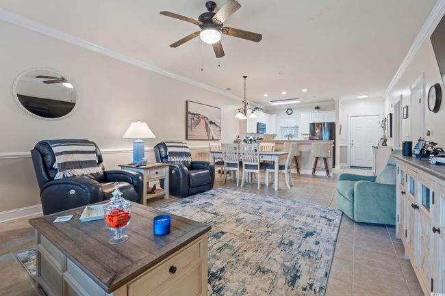 Living room with crown molding, ceiling fan, light tile patterned floors, and recessed lighting | Image 4