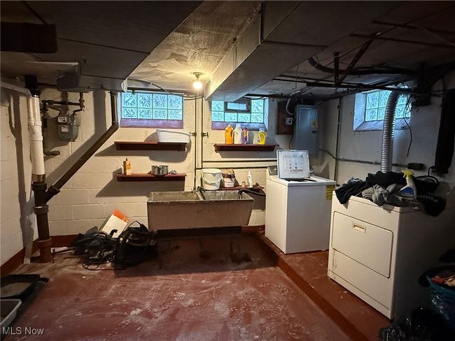 Basement with a sink and washing machine and clothes dryer | Image 13