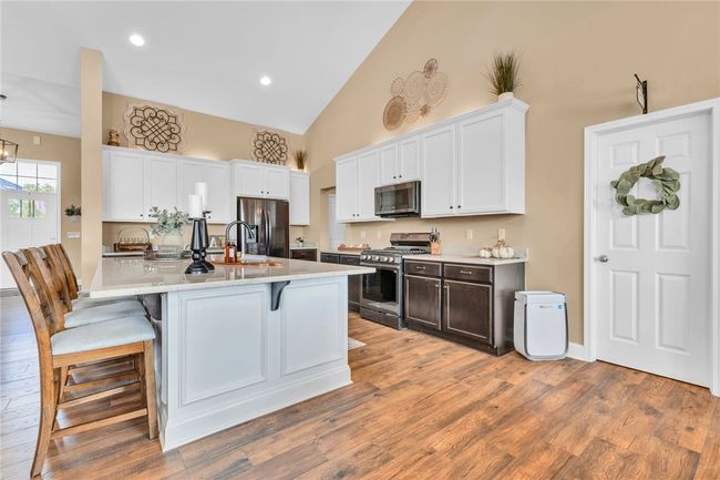 Gorgeous two-tone kitchen with SS appliances, gas stove, granite counters, & massive center island. | Image 9