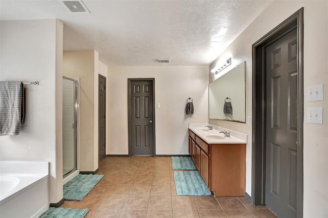 Luxurious ensuite bath featuring dual sinks, a spacious shower and soaking tub | Image 35