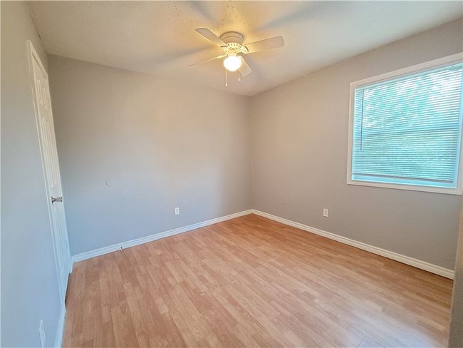 Unfurnished room with light wood-type flooring and ceiling fan | Image 10