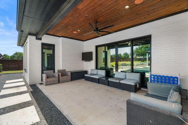 View of patio with an outdoor hangout area and ceiling fan | Image 32