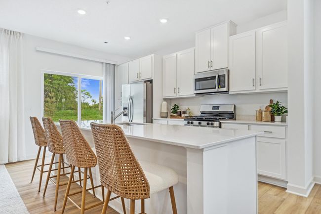 (Photo of decorated model, actual home's finishes will vary) Spacious kitchen opens to the patio. | Image 4