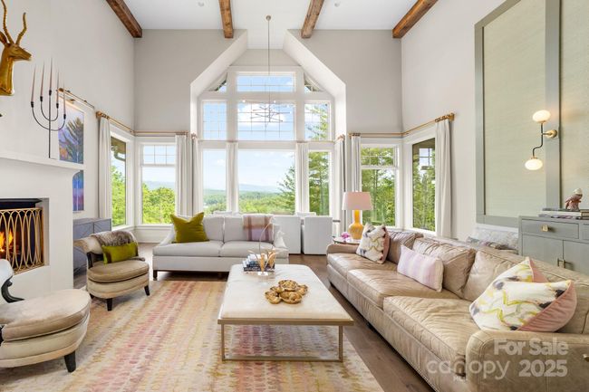 Enter into an elegant living area graced with views of the Linville Mountains and Lake James . | Image 4