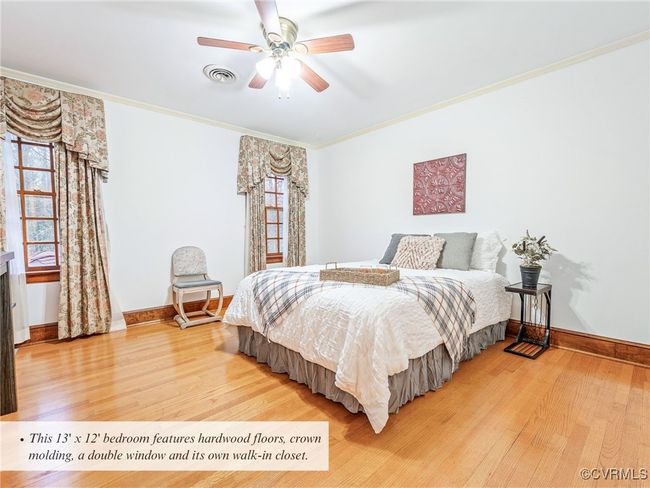 This 13' x 12' bedroom features hardwood floors, crown molding, a double window and its own walk-in closet. | Image 31