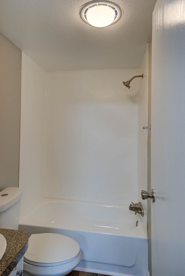 Full bath with a textured ceiling, shower / bath combination, and vanity | Image 17