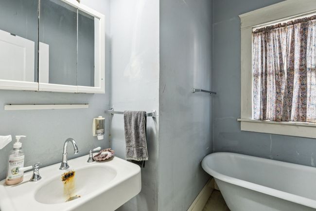 Bathroom with a sink and a soaking tub | Image 14