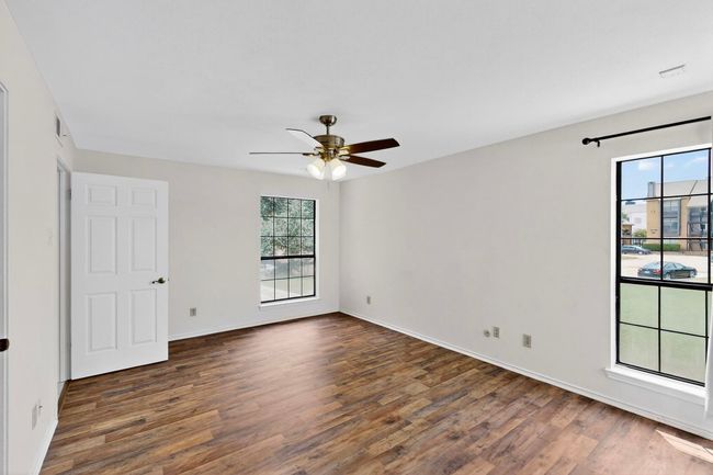 Spare room featuring wood finished floors, ceiling fan, and baseboards | Image 29