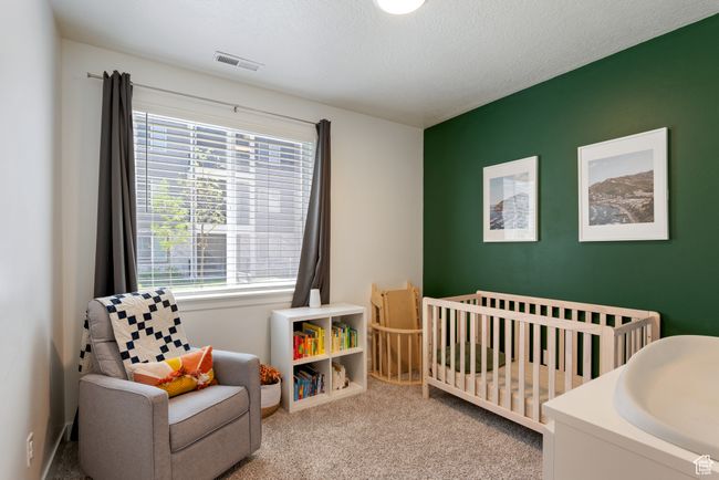 Carpeted bedroom featuring a crib and multiple windows | Image 8