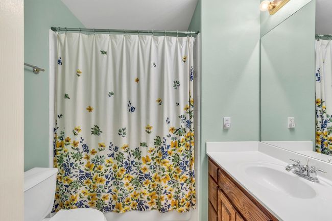 Full bath with curtained shower, toilet, and vanity | Image 26