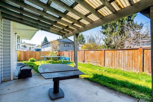 View of patio featuring a fenced backyard and a trampoline | Image 9