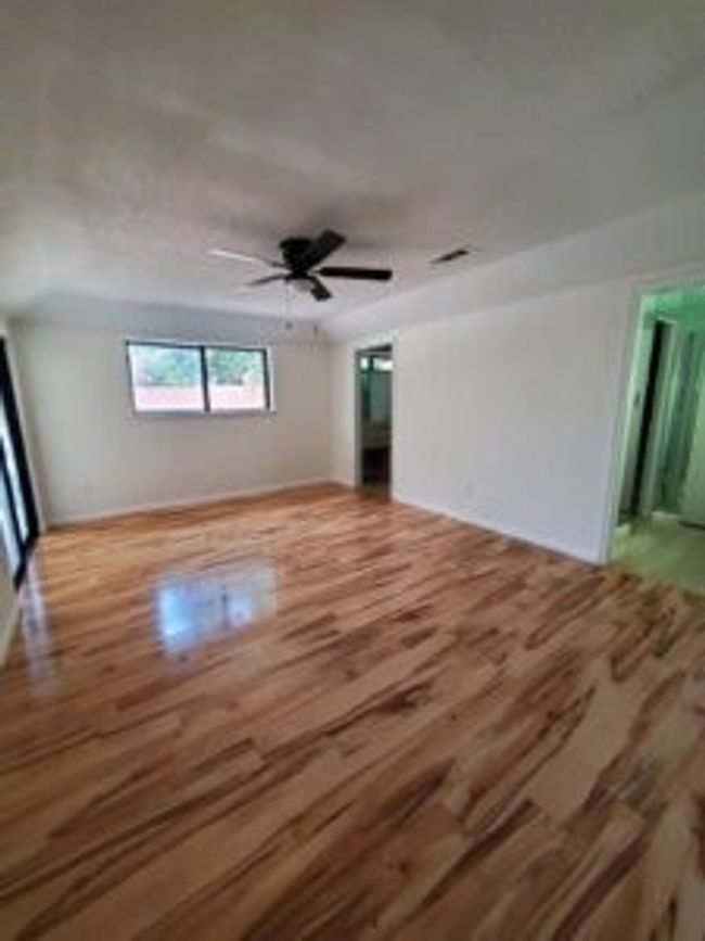 Unfurnished room featuring wood finished floors and ceiling fan | Image 11