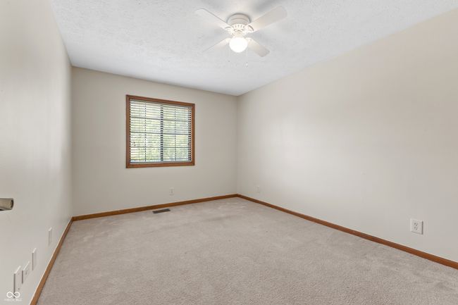 carpeted spare room featuring ceiling fan, baseboards, and a textured ceiling | Image 24
