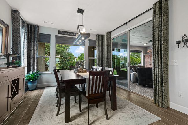 Dining area with wood finished floors, baseboards, and ceiling fan | Image 15