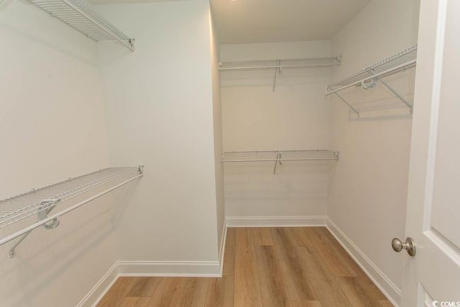 Walk in closet featuring light wood-type flooring | Image 26