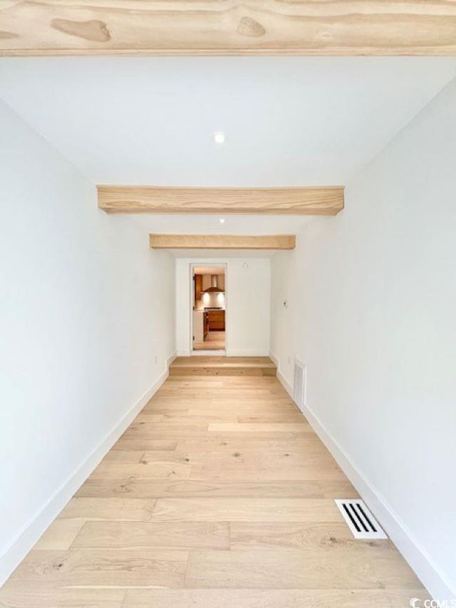 Hallway featuring light wood-style floors and baseboards | Image 26