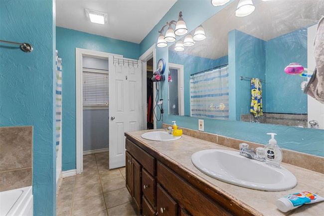 Bathroom featuring tile patterned flooring, vanity, and separate shower and tub | Image 16